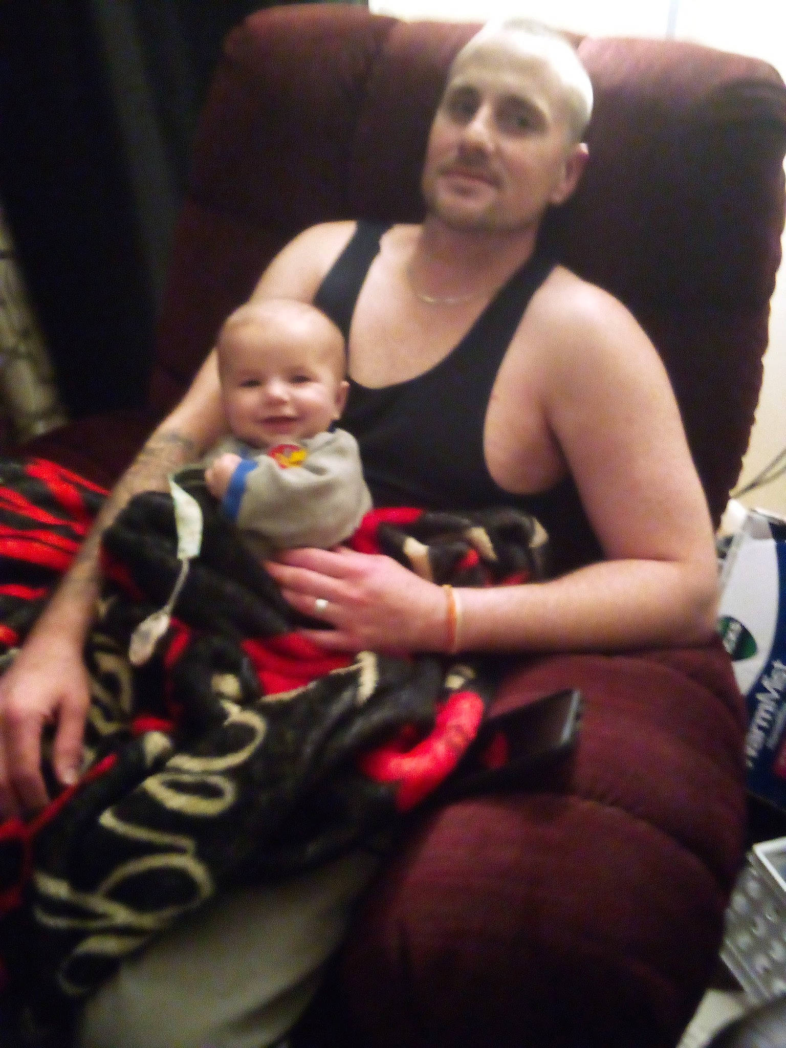 Mark is registered to the contest to win money with this photo: abdomen, arm, baby, baby_carriage, baby_products, carmine, chair, chest, child, comfort, event, fun, happy, human_leg, joy, lap, person, room, sitting, smile