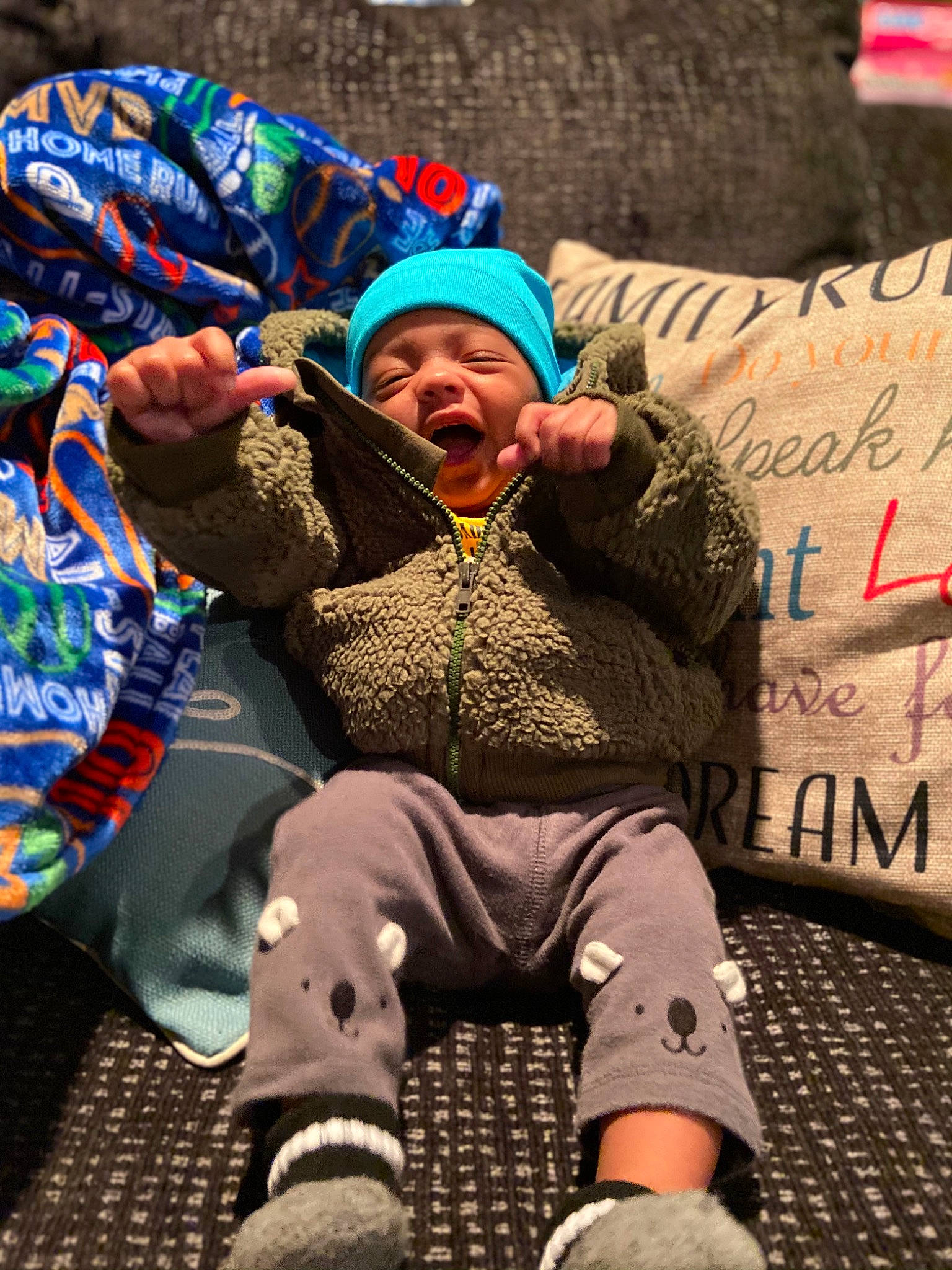 Arizona is registered to the contest to win money with this photo: baby_toddler_clothing, beanie, bonnet, handwriting, headwear, hood, knit_cap, person, winter