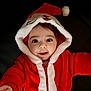Tom a rejoint le concours — aidez-le/la à gagner de superbes lots ! baby, child, face, smile, hood, red_clothing, white_trim, christmas, festive, holiday, cute, infant, portrait, happy, young_child, warm_clothing, indoor, closeup, person, apparel
