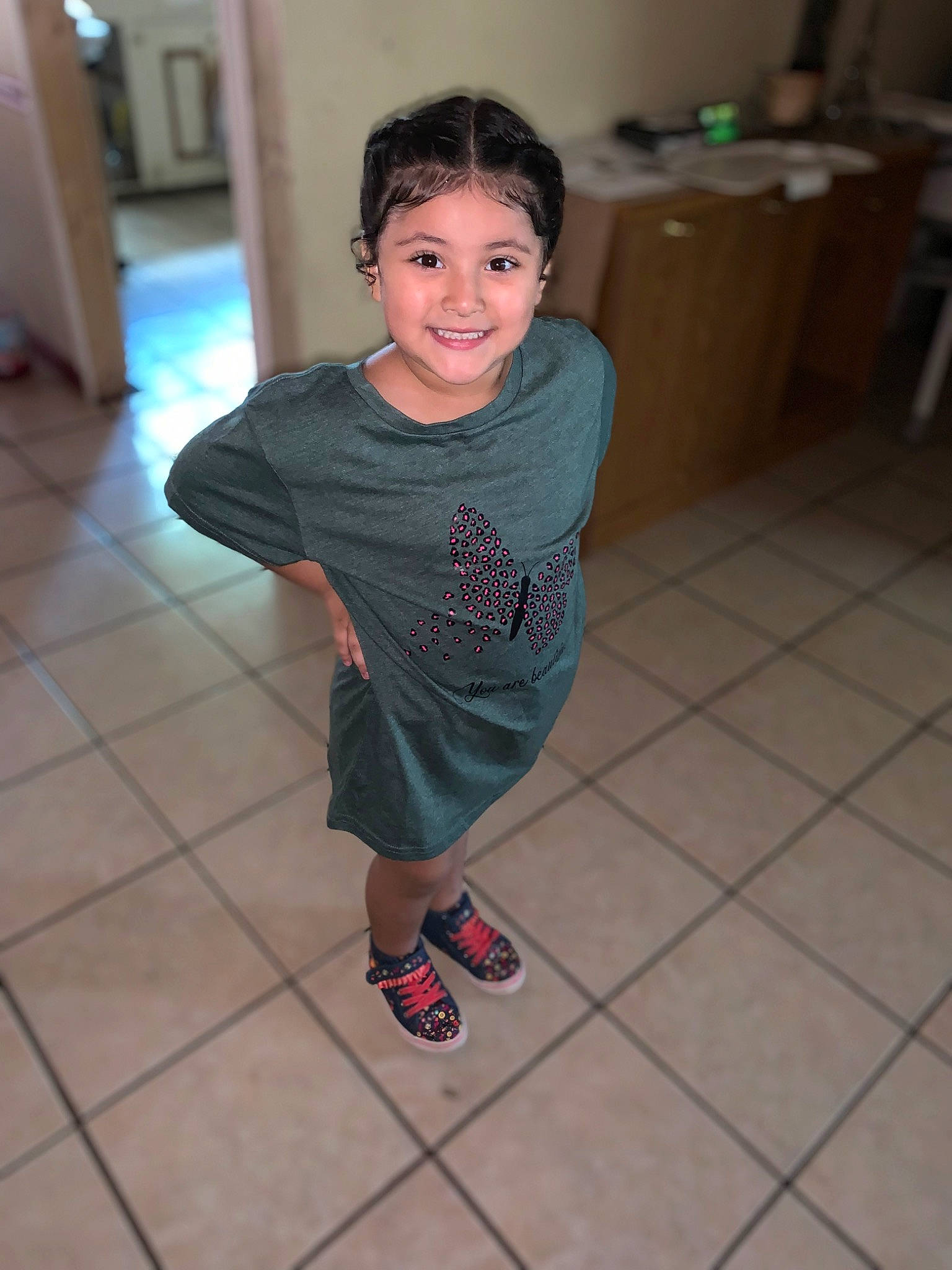 Lilliana is registered to the contest to win money with this photo: child, event, eye, floor, flooring, fun, hair, happy, hardwood, head, human_leg, joint, joy, knee, leisure, person, sandal, smile, t_shirt, thigh