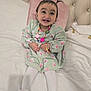 baby, bed, child, cozy, cute, cute_expression, floral_pattern, furniture, green_dress, happy, indoor, jewelry, necklace, pigtails, pink_pillow, portrait, slippers, smiling, toddler, white_tights