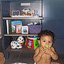 Zakar joined the competition — help win amazing prizes! toddler, child, diaper, toy, blanket, sitting, indoor, shelf, books, stuffed_animal, television, floor, curly_hair, playing, colorful, plastic_toy, baby, room, furniture, cute