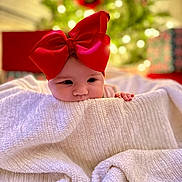 Arizona joined the competition — help win amazing prizes! baby, infant, red_bow, blanket, christmas_tree, bokeh, present, cute, face, eyes, hands, portrait, holiday, gift, smile, cozy, soft_texture, indoordecor, festive, wrapped_present