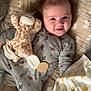 baby, bed, blanket, bright_eyes, closeup, cozy, hair_spike, happy, infant, nursery, onesie, pillow, plush_toy, portrait, rosy_cheeks, sleepwear, smiling, stuffed_giraffe, teether, toy