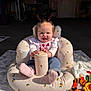 baby, baby_chair, blanket, cup, cute, garage, happy, infant, inflatable_chair, jeans, onesie, pigtails, playmat, portrait, seat, smiling, sock, sunlight, toddler, toy