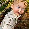 Joel joined the competition — help win amazing prizes! blue_eyes, boy, casual_clothing, child, curious, curly_hair, cute, daylight, dirt, grass, greenery, logs, nature, outdoor, plaid_shirt, portrait, smiling, toddler, wood, young_child