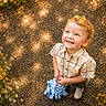 Joel is registered to the contest to win money with this photo: blue_eyes, casual_clothing, child, curly_hair, cute, greenery, happy, nature, octopus_toy, outdoor, pathway, playful, plush_toy, shoes, short_sleeves, smiling, summer, sunlight, toddler, wildflowers