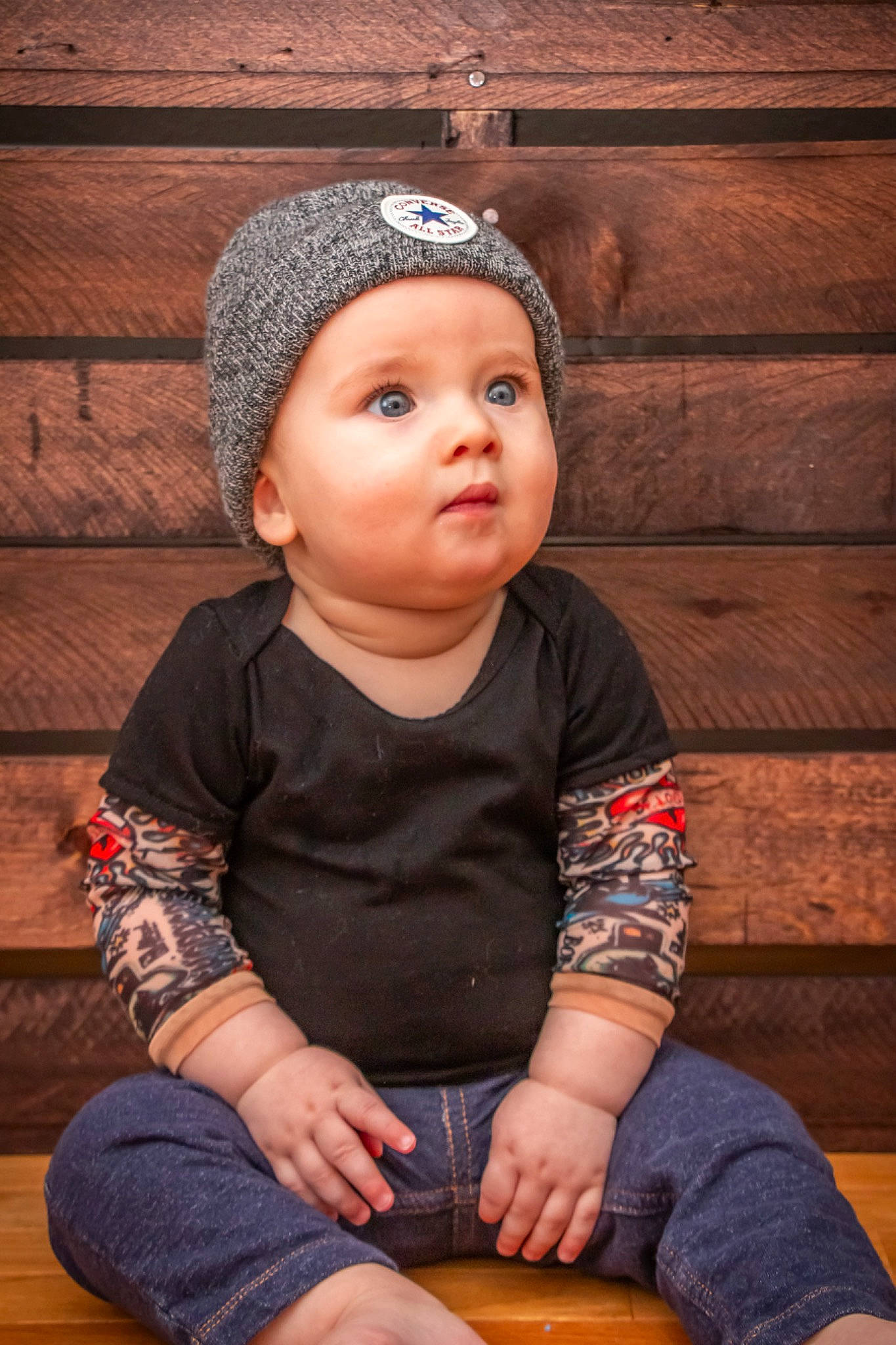 Maximus joined the competition — help win amazing prizes! baby, beanie, cap, child, child_model, fashion_accessory, hair_accessory, headband, headgear, headwear, knit_cap, knitting, person, portrait, portrait_photography, sitting, surprise, toddler, wood