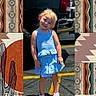 child, girl, toddler, smiling, portrait, outdoor, sunny, blue_dress, pink_sandals, pickup_truck, parking_lot, asphalt, yellow_line, head_tilt, blonde_hair, standing, fashion, western_pattern, collage, photograph