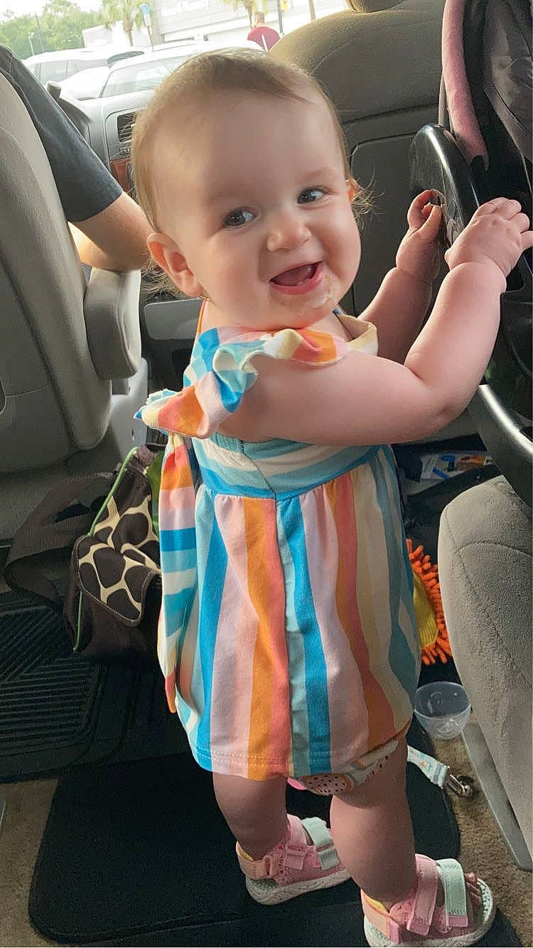 Aubrie is registered to the contest to win money with this photo: auto_part, baby, baby_products, baby_toddler_clothing, car_seat, car_seat_cover, child, family_car, fun, gesture, happy, joy, person, personal_luxury_car, sitting, skin, smile, steering_wheel, thumb, toddler