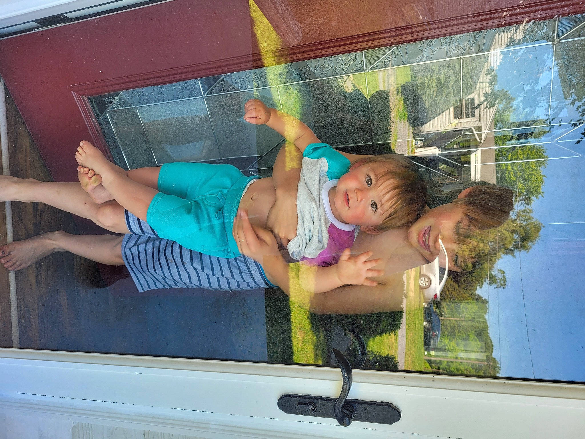 Rowan is registered to the contest to win money with this photo: automotive_exterior, automotive_mirror, child, fun, glass, human_leg, leg, leisure, motor_vehicle, muscle, person, recreation, shorts, summer, swimwear, t_shirt, thigh, toddler, vehicle_door, window