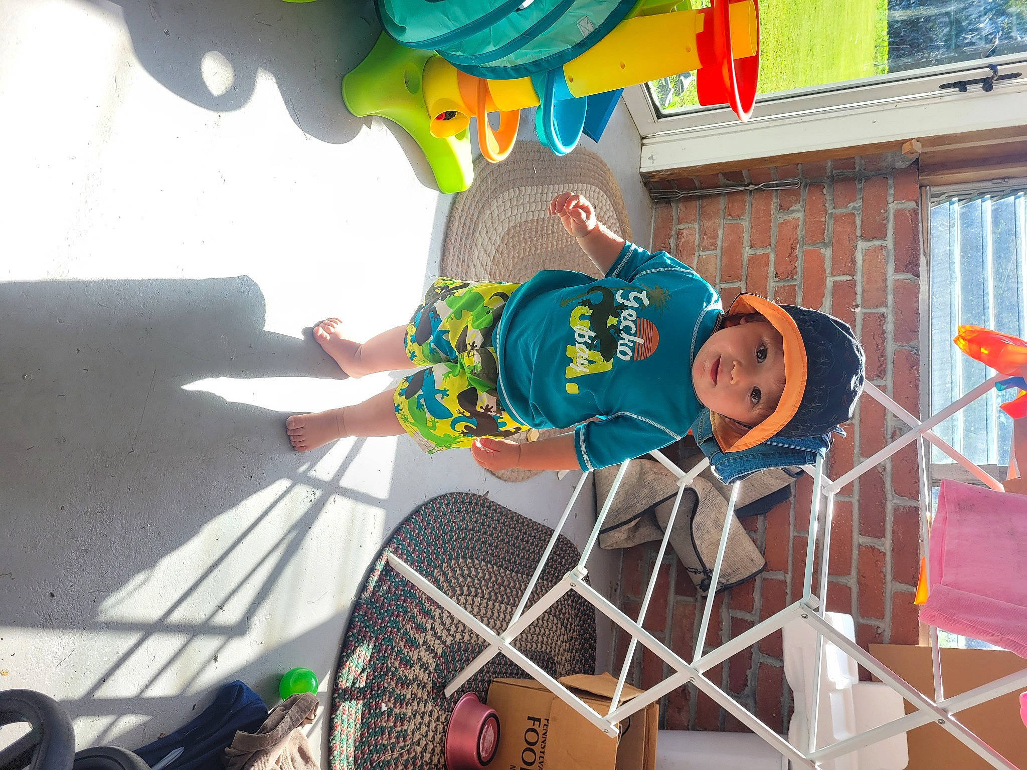 Rowan is registered to the contest to win money with this photo: chair, child, event, fun, hat, headwear, leisure, person, play, recreation, shorts, smile, t_shirt, tree, vacation, visual_arts