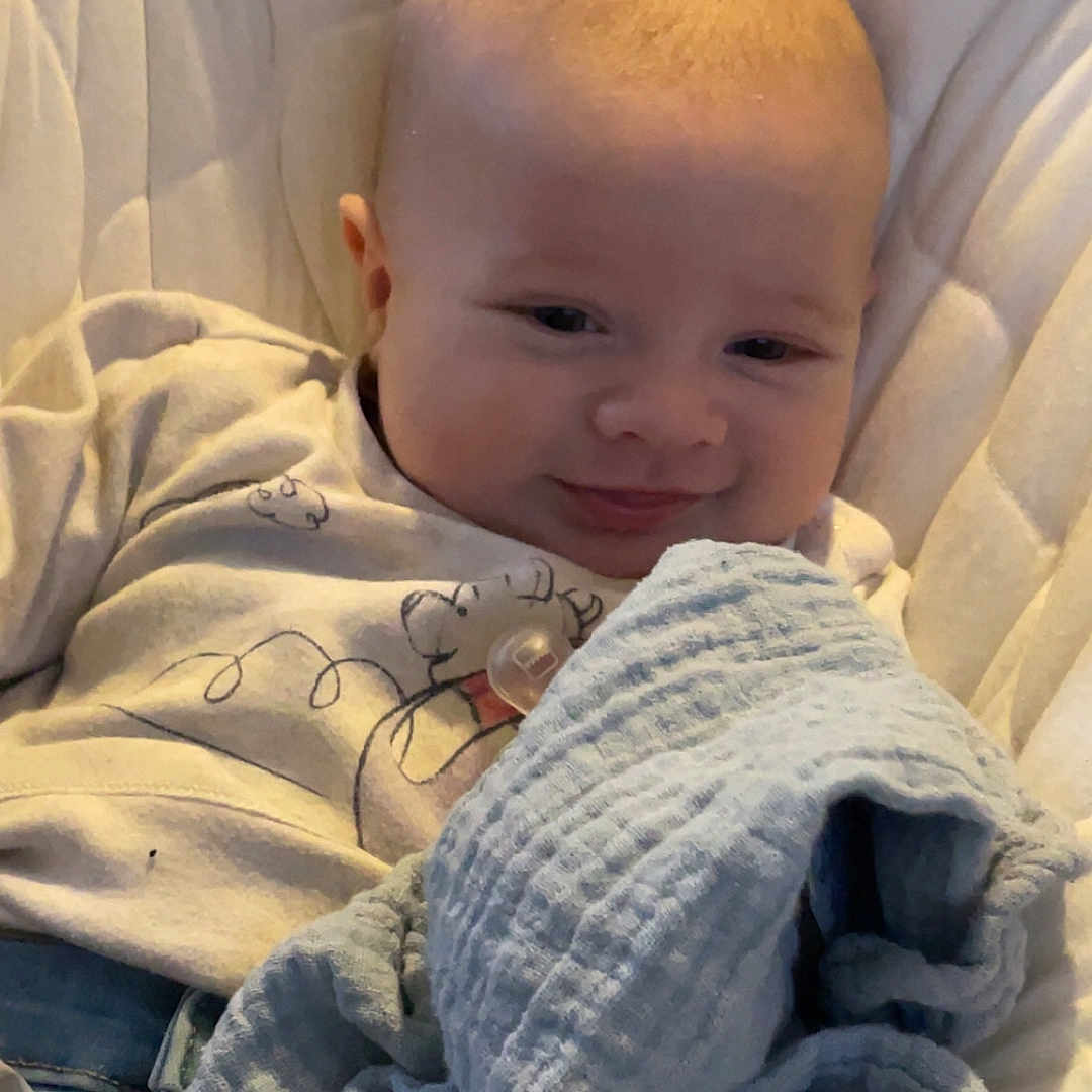 Oakley joined the competition — help win amazing prizes! baby, bed, blanket, clothing, couch, crib, cushion, face, furniture, head, homedecor, knitwear, linen, newborn, pants, person, photography, portrait, quilt, sweater