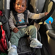 Daemari is registered to the contest to win money with this photo: accessories, bag, boy, car, child, clothing, face, footwear, handbag, head, male, pants, person, photography, portrait, shoe, sitting, sneaker, transportation, vehicle