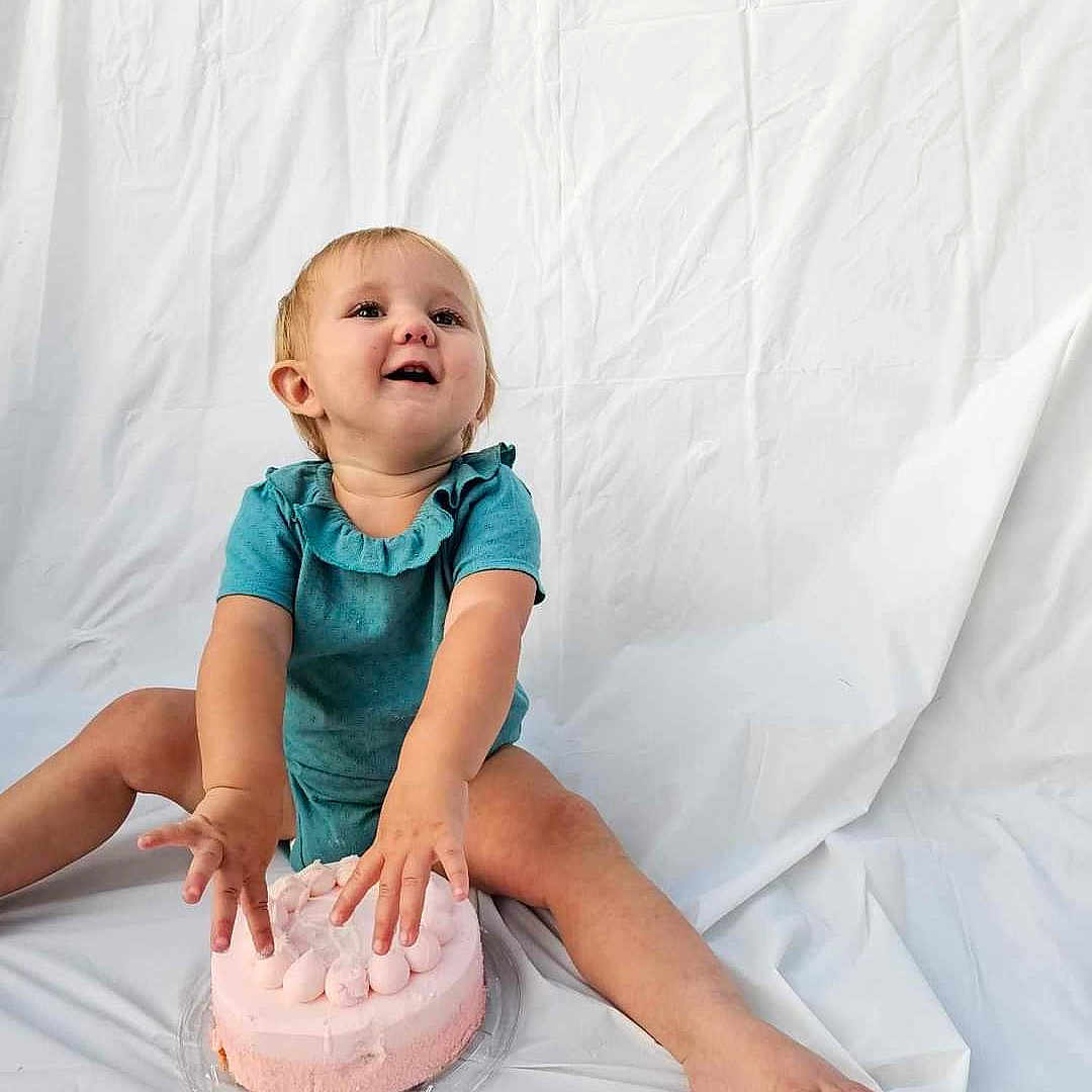 Ellie joined the competition — help win amazing prizes! baby, birthdaycake, cake, clothing, cream, dessert, face, food, fun, happy, head, icing, people, person, photography, portrait, sitting, sleeve, smile, sweets