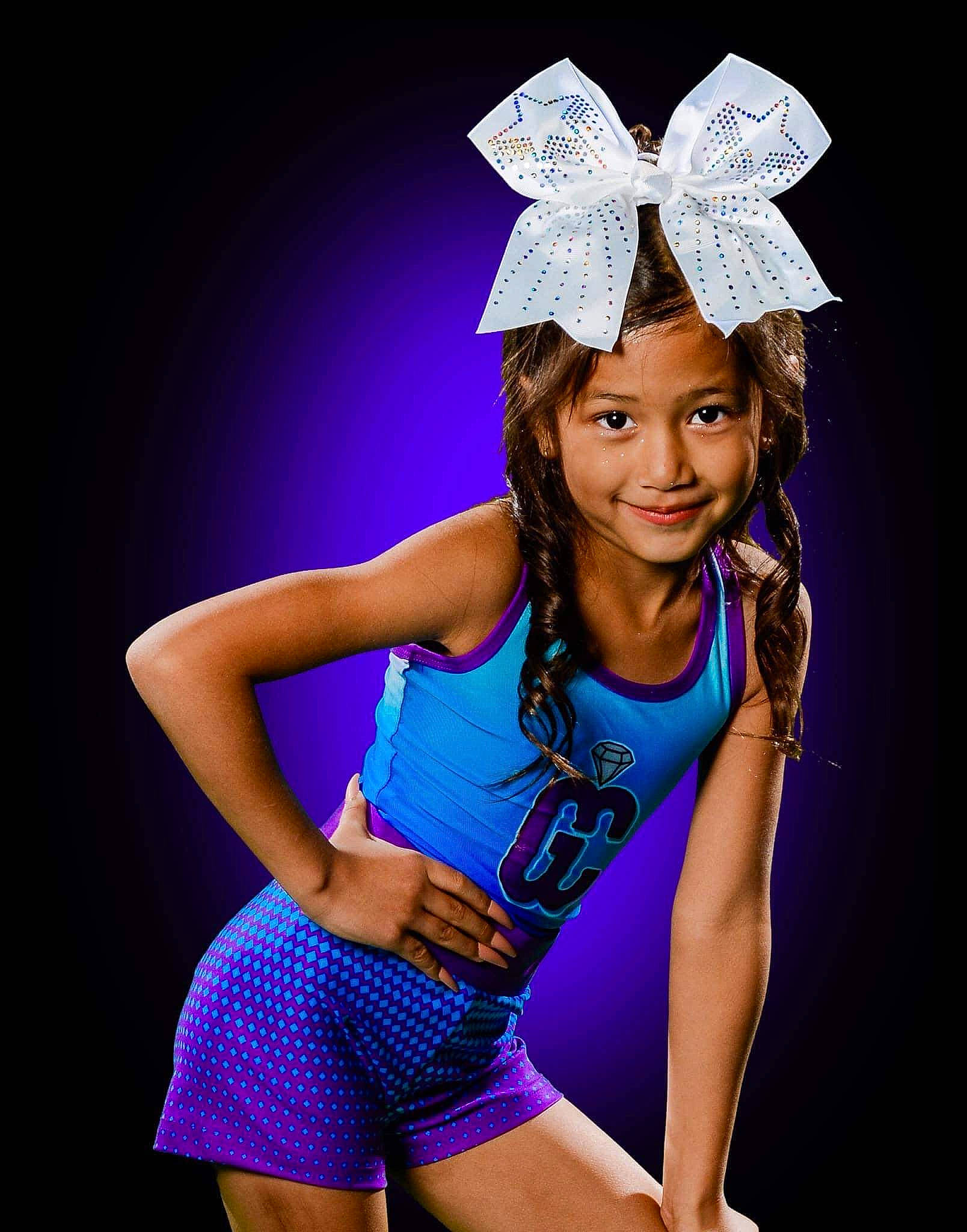 Sierra is registered to the contest to win money with this photo: black_hair, electric_blue, entertainment, event, fashion_design, flash_photography, fun, glove, happy, headwear, human_body, human_leg, joy, knee, magenta, performing_arts, person, pink, purple, smile