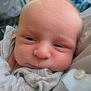 Zach is registered to the contest to win money with this photo: baby, newborn, infant, face, skin, eyes, clothing, onesie, sleepy, cute, portrait, closeup, soft, cozy, newborn_clothes, person, child, head, expression, warm