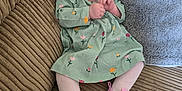 Alyissa joined the competition — help win amazing prizes! baby, infant, child, dress, floral_pattern, pink_shoes, tights, couch, pillow, cozy, indoors, portrait, cute, small_feet, seated, looking_at_camera, soft_texture, comfort, clothing, expression