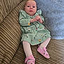 Alyissa joined the competition — help win amazing prizes! baby, infant, child, dress, floral, pink_shoes, couch, pillow, cozy, indoors, cute, portrait, clothing, footwear, tights, furniture, person, sitting, looking, young