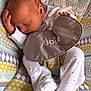 baby, baby_seat, bib, child, cute, footwear, hand, indoors, infant, joie, newborn, pajamas, patterned_fabric, peaceful, polka_dots, portrait, resting, sleeping, small_hands, soft_lighting