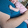 Alyissa is registered to the contest to win money with this photo: baby, infant, child, smiling, laughing, hugging, cuddling, adult, man, blue_shirt, pink_onesie, indoor, closeup, arm, skin, furniture, couch, happy, person, family