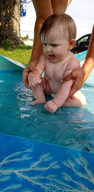 Kendall is registered to the contest to win money with this photo: aqua, arm, azure, baby, bathing, finger, fun, gesture, green, hand, happy, human_body, leisure, person, photograph, recreation, summer, swimming_pool, toddler, vertebrate