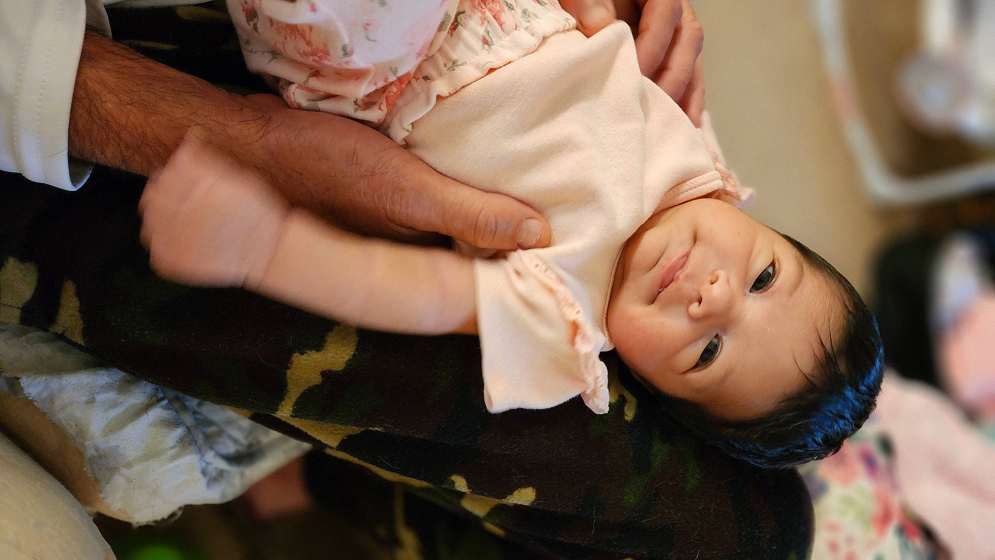 Avianna is registered to the contest to win money with this photo: baby, baby_toddler_clothing, cheek, child, eye, finger, gesture, hand, happy, human_body, nail, nose, pattern, person, skin, sleeve, thumb, toddler, tree, wood