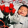 baby, newborn, infant, portrait, smile, blanket, knit_blanket, red_tulips, flowers, artificial_flowers, heart_garland, hearts, green_leaves, sunglasses, orange_sunglasses, onesie, cozy, face, hands, closeup