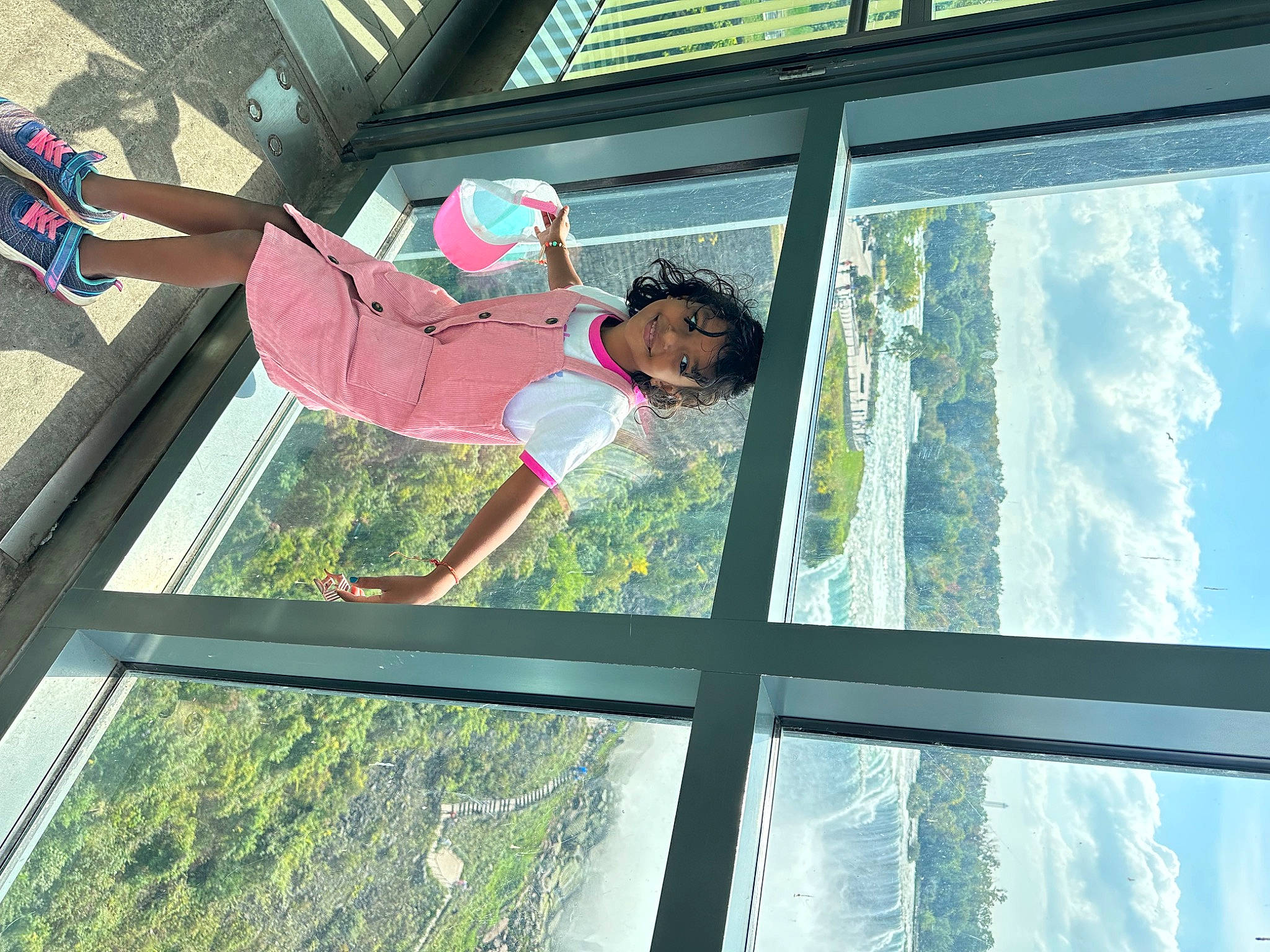 Akshita joined the competition — help win amazing prizes! daylighting, elbow, electric_blue, facade, fun, glass, hat, joy, leisure, person, recreation, shade, shorts, sky, smile, t_shirt, tree, vacation, water, window