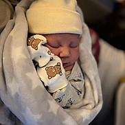 Arlo joined the competition — help win amazing prizes! newborn, baby, sleeping, blanket, hat, mittens, bear_print, cozy, infant, cute, wrapped, soft, tiny, peaceful, indoor, warm, closeup, person, child, portrait