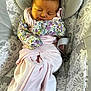 Addison joined the competition — help win amazing prizes! baby, newborn, sleeping, infant, pink_clothing, floral_mittens, baby_seat, patterned_fabric, animal_print, leaf_print, cozy, soft, peaceful, face, person, child, indoors, cute, resting, wrapped