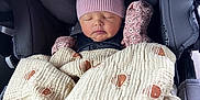 Addison joined the competition — help win amazing prizes! baby, car_seat, blanket, pink_hat, mittens, sleeping, infant, child, graco, protectplus, cozy, soft_texture, patterned_blanket, resting, cute, wrapped_up, indoor, seatbelt, headrest, peaceful
