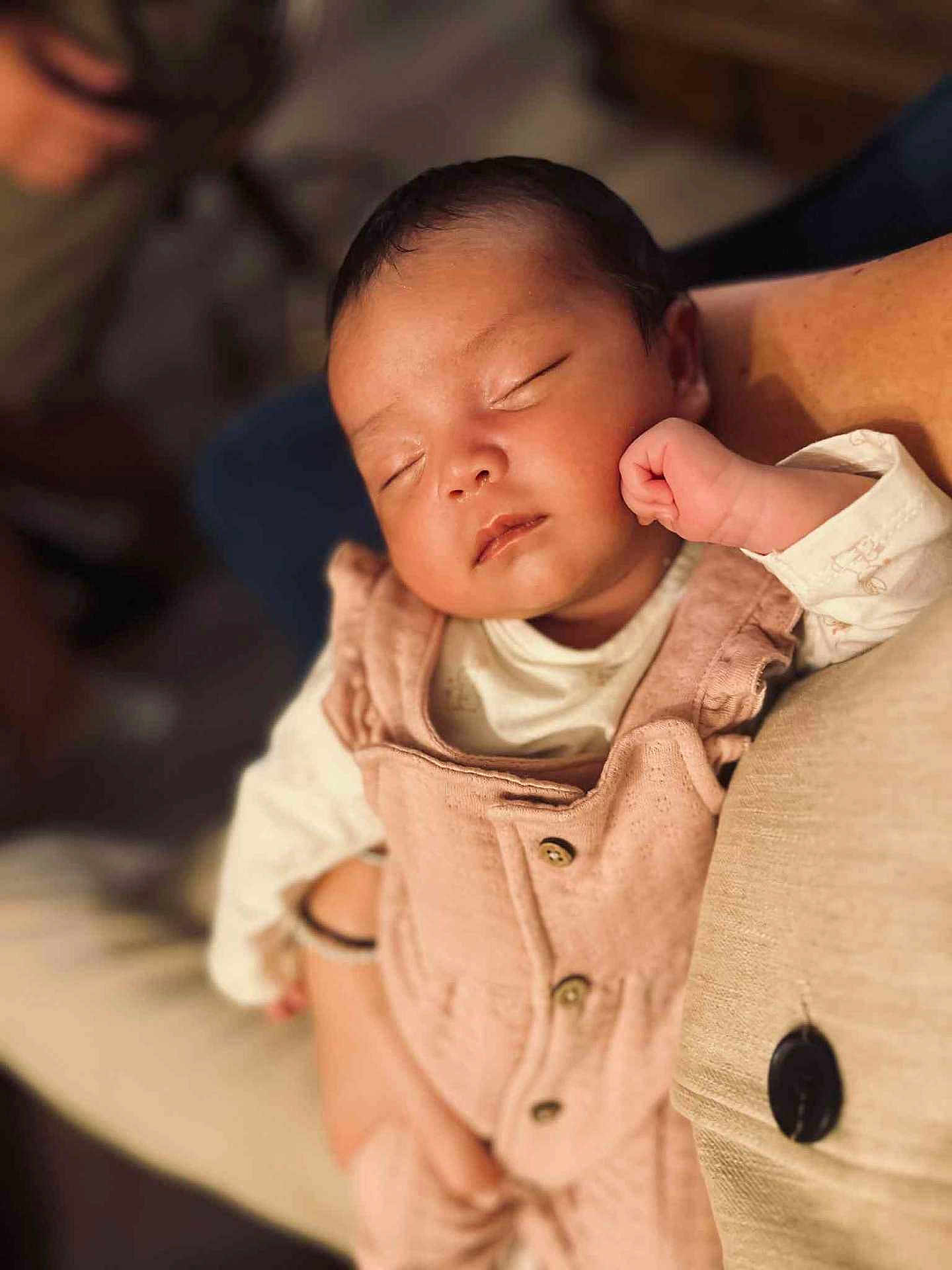 Victoire a rejoint le concours — aidez-le/la à gagner de superbes lots ! baby, sleeping, infant, pink_overalls, peaceful, closeup, person, arm, soft_lighting, indoor, portrait, child, cute, resting, cozy, human, skin, clothing, hand, newborn