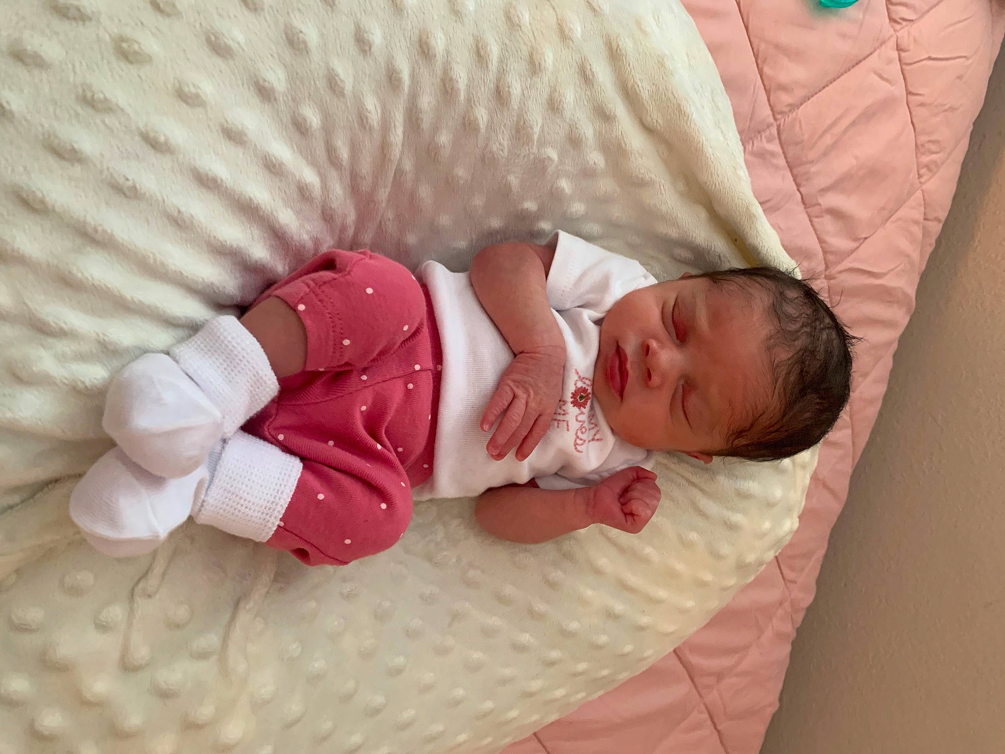 Khai is registered to the contest to win money with this photo: arm, baby, baby_products, baby_sleeping, baby_toddler_clothing, child, comfort, finger, flooring, foot, hand, lap, linens, pattern, person, sitting, skin, sleeve, sock, textile