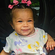 Adahra is registered to the contest to win money with this photo: baby, child, clothing_pattern, colorful_clothing, curly_hair, cute, cute_baby, face, hand, happy, indoors, infant, mickey_mouse, natural_light, person, pink_bow, portrait, sitting, smile, toddler