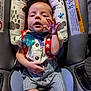 baby, infant, car_seat, clothing, suspenders, bow_tie, hand, face, expression, seat, striped_shorts, buttoned_shirt, comfort, child, cute, indoor, young, padded, safety, person