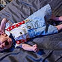 Jesse joined the competition — help win amazing prizes! baby, infant, yawning, clothing, suspenders, bow_tie, striped_shorts, bed, blanket, sleepy, stretching, cute, person, newborn, lying_down, indoors, soft_texture, skin, small_hands, small_feet