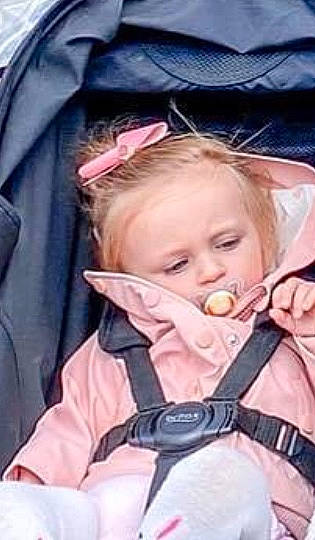 Daisy is registered to the contest to win money with this photo: baby, baby_products, baby_safety, baby_toddler_clothing, blond, cheek, child, comfort, iris, jacket, person, product, skin, strap, toddler