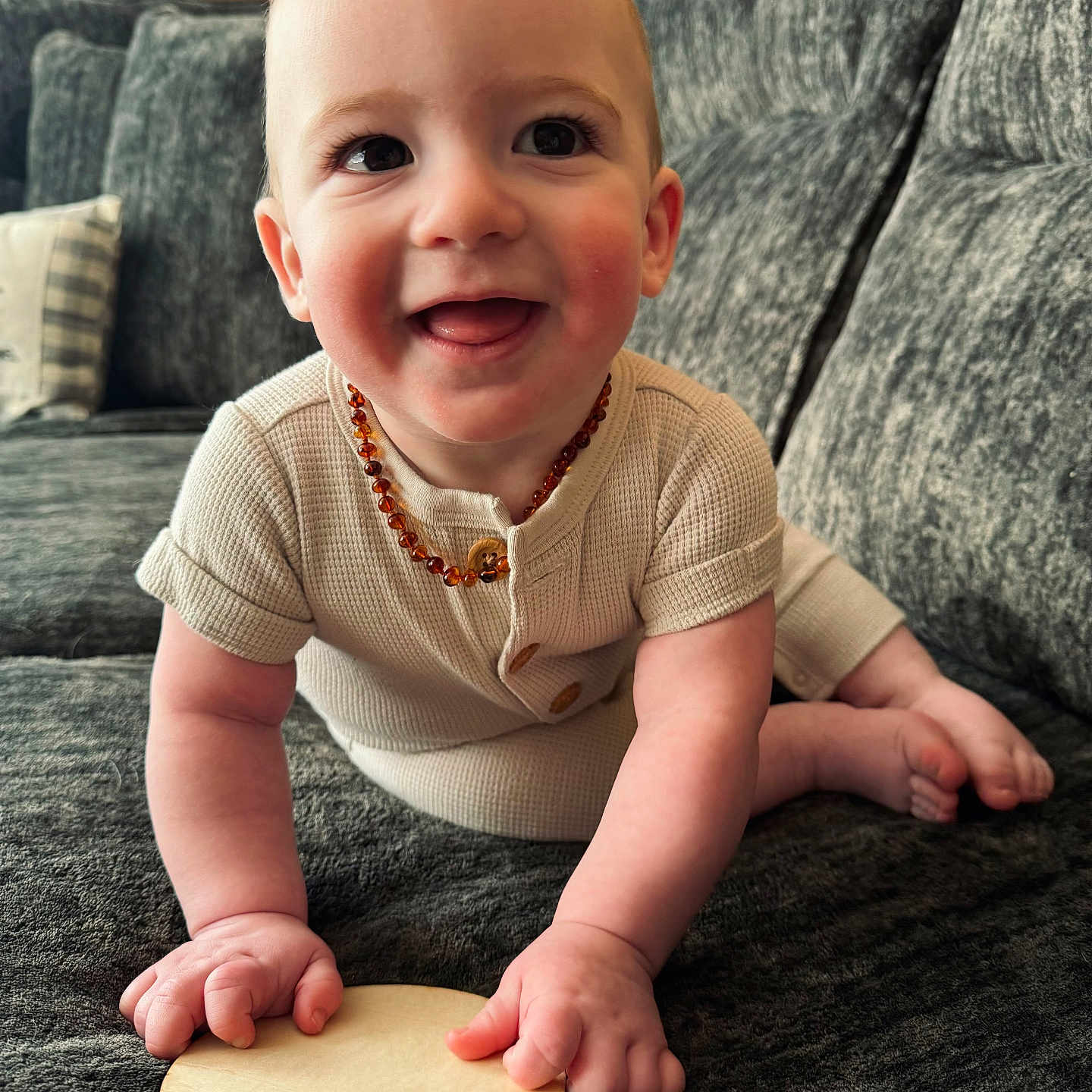 Jaxen joined the competition — help win amazing prizes! accessories, baby, bodypart, couch, face, finger, furniture, hand, happy, head, jewelry, necklace, person, photography, pingpong, pingpongpaddle, portrait, racket, sitting, sport