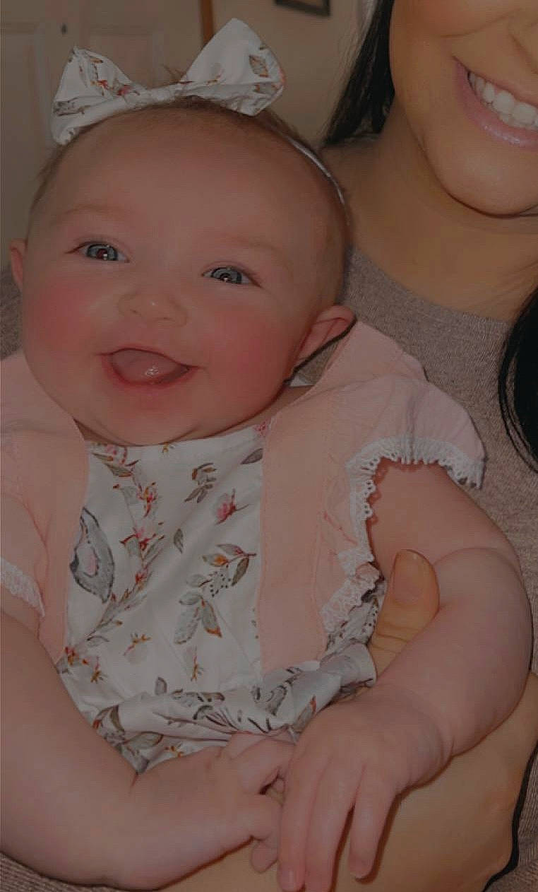 Paisley is registered to the contest to win money with this photo: baby, baby_toddler_clothing, cheek, chin, clothing, eyebrow, face, facial_expression, gesture, iris, lip, mouth, nose, organ, person, pink, product, skin, sleeve, smile