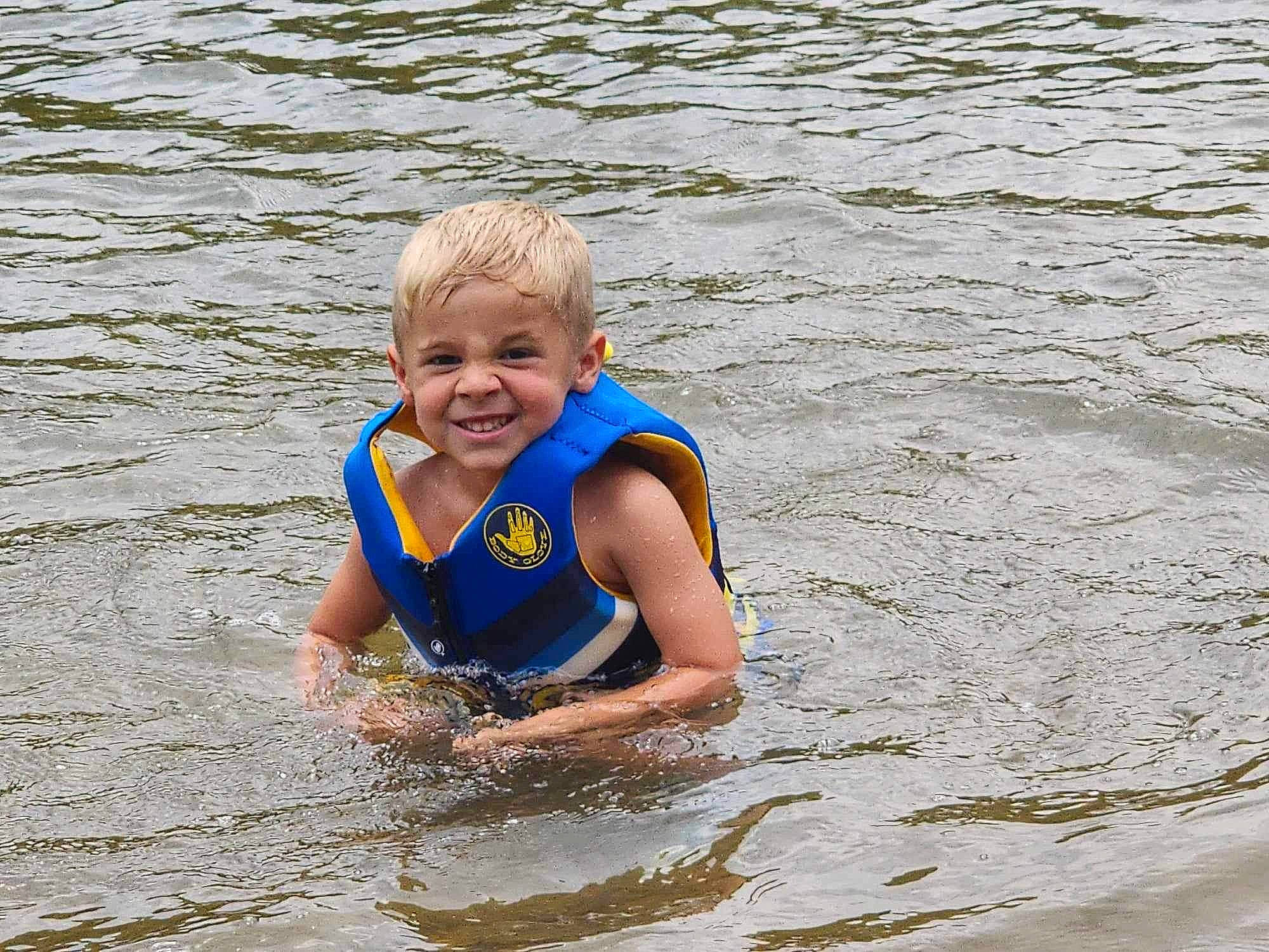 Harlo joined the competition — help win amazing prizes! baby_toddler_clothing, bathing, beach, child, facial_expression, fun, happy, head, joy, lake, leisure, mammal, person, personal_protective_equipment, recreation, sea, smile, toddler, vacation, vertebrate