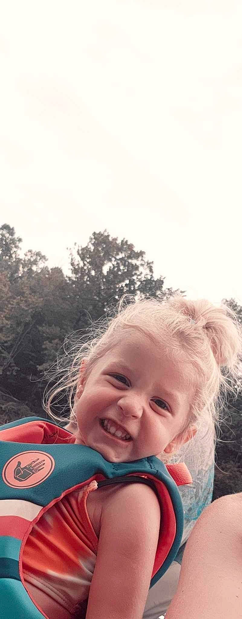 Kaislee is registered to the contest to win money with this photo: baby, child, cloud, face, fun, grass, happy, joy, laugh, leisure, lip, nose, people_in_nature, person, personal_protective_equipment, recreation, sky, smile, toddler, travel