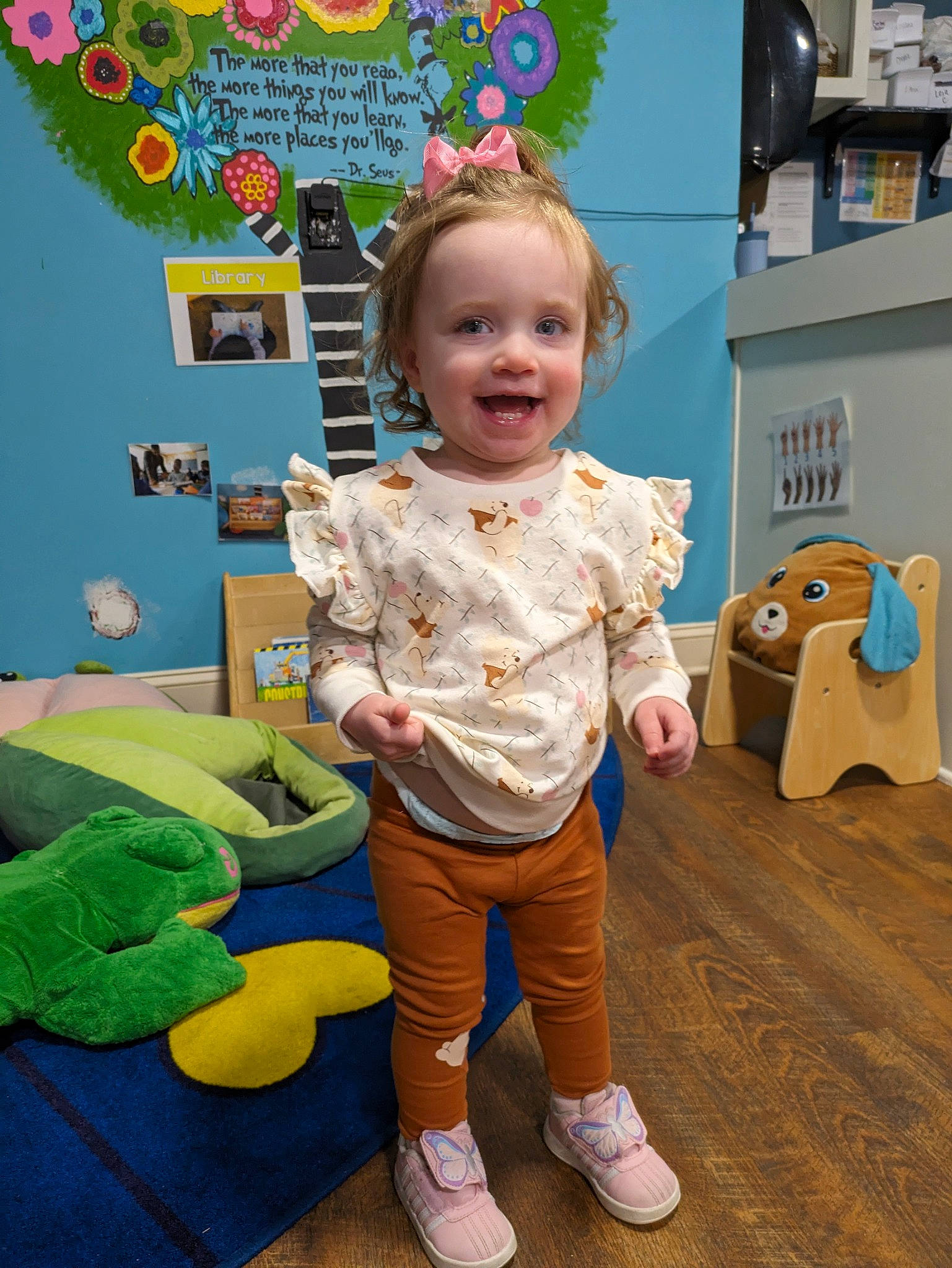 Everlee is registered to the contest to win money with this photo: baby, baby_toddler_clothing, box, child, flooring, fun, happy, joy, kindergarten, leisure, person, play, room, shelf, shipping_box, smile, stuffed_toy, t_shirt, textile, toddler