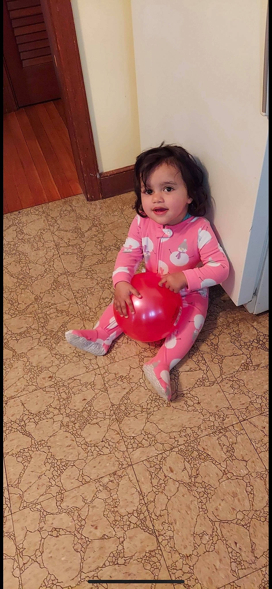 Catherine is registered to the contest to win money with this photo: baby_toddler_clothing, barefoot, cheek, comfort, floor, flooring, foot, fun, happy, hardwood, human_leg, leg, magenta, person, pink, rectangle, sitting, sleeve, thigh, toddler