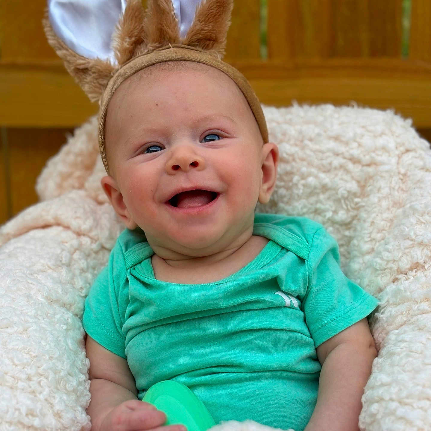 Kaysen is registered to the contest to win money with this photo: baby, clothing, couch, cushion, face, furniture, happy, head, homedecor, indoors, laughing, newborn, person, photography, portrait, quilt, sitting, smile, t_shirt, toy