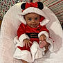 Leila joined the competition — help win amazing prizes! baby, infant, christmas, holiday, festive, red_clothing, white_fur, bow, ears, blanket, gift_wrap, lights, smiling, cute, cozy, indoor, celebration, present, happy, child