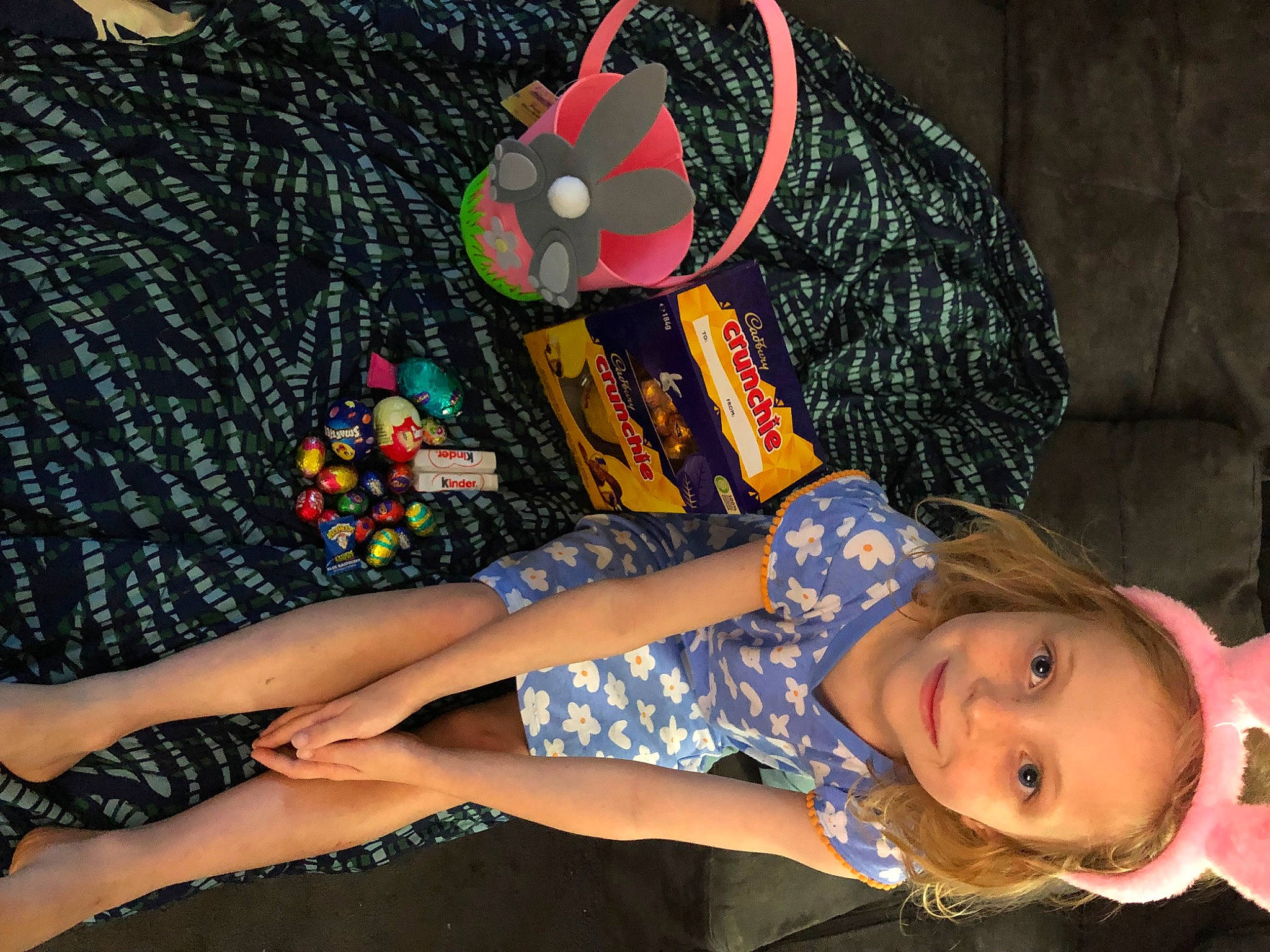 Evelyn Kate is registered to the contest to win money with this photo: beanie, child, craft, electric_blue, fashion_accessory, fun, grass, happy, human_leg, joy, knee, lap, pattern, person, sitting, sleeve, smile, t_shirt, thigh, toddler