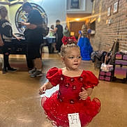 Legacy joined the competition — help win amazing prizes! background, blur, child, costume, cute, decor, dress_up, event, floor, footwear, girl, hair_bow, indoor, number_tag, people, person, red_dress, standing, wall, white_shoes