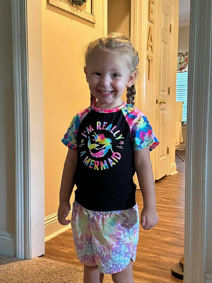 Brynlee is registered to the contest to win money with this photo: baby_toddler_clothing, door, electric_blue, eye, happy, head, joint, joy, magenta, neck, person, shoulder, sleeve, smile, standing, t_shirt, textile, thigh, toddler, trunk