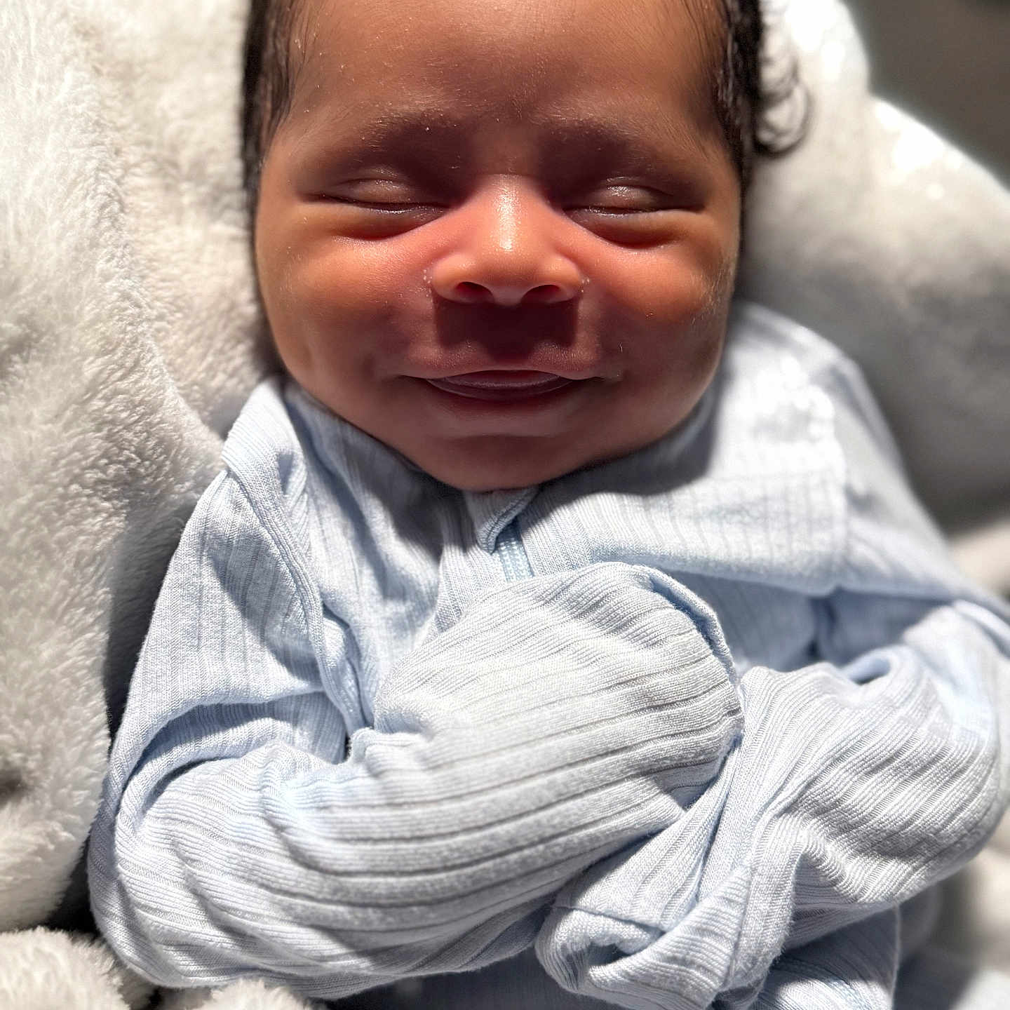 Savior is registered to the contest to win money with this photo: baby, blanket, child, closeup, comfort, cozy, cute, expression, face, hands, infant, newborn, pajamas, peaceful, portrait, resting, sleeping, smile, soft, warm